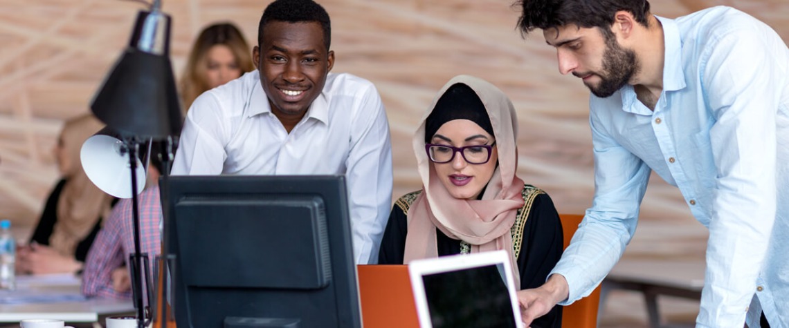 Students gathered around a computer